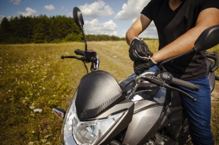 man-putting-gloves-motorbike_23-2148322011